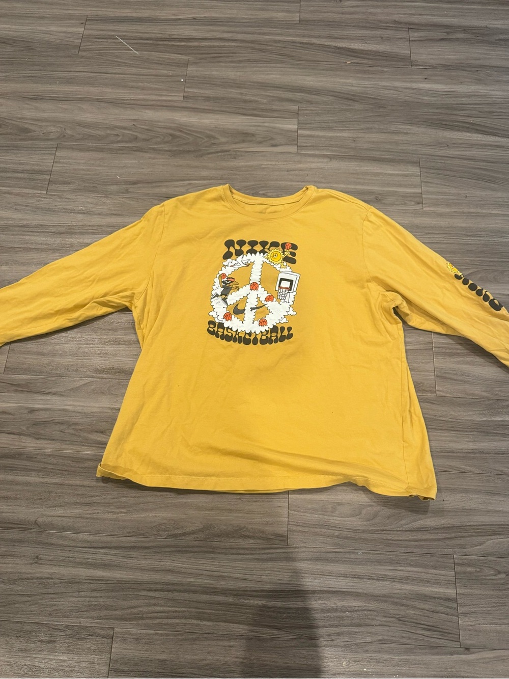 Nike Yellow Long-Sleeve Graphic Tee with Peace Flower Motif